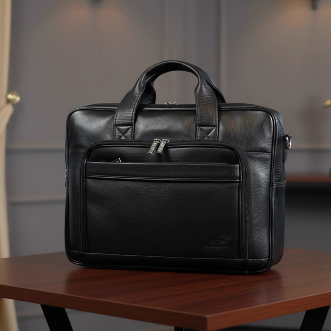 black leather briefcase bag on wooden table in modern office setting